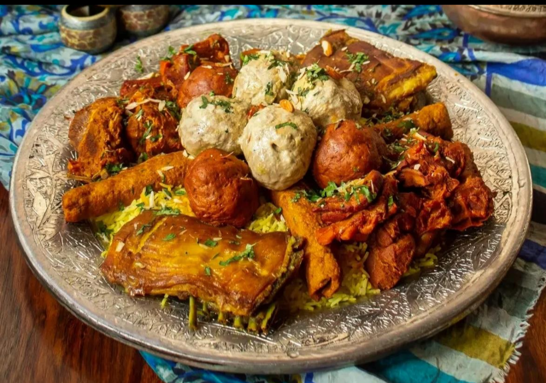 Wazwan — Kashmir's ceremonial multi-course feast traditionally served on a shared copper trami.